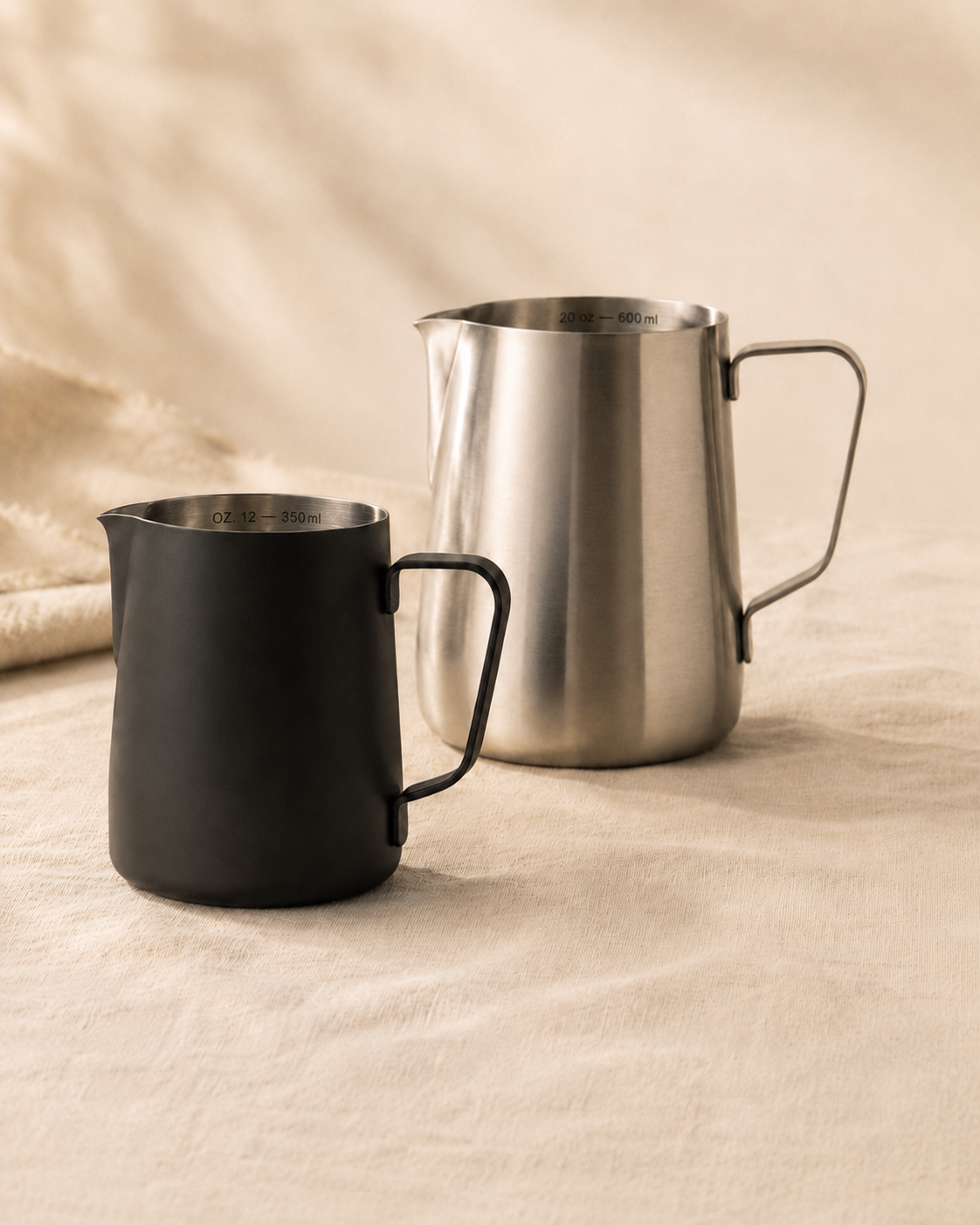ElyseraRitual milk pitcher size comparison —  black 350ml and brushed silver 600ml stainless steel steaming pitchers